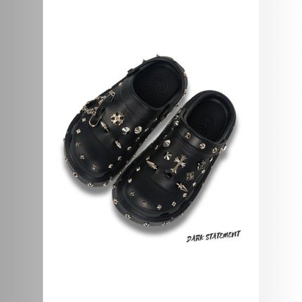 Black platform with rivets clogs on a white background with 'Dark Statement' brand.