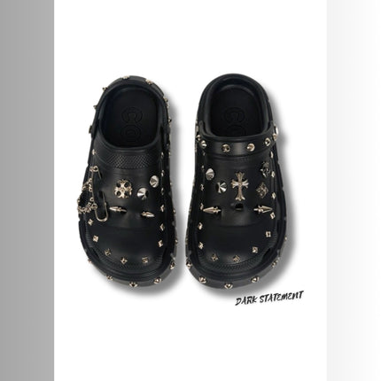Black platform with rivets clogs on a white background with 'Dark Statement' brand.