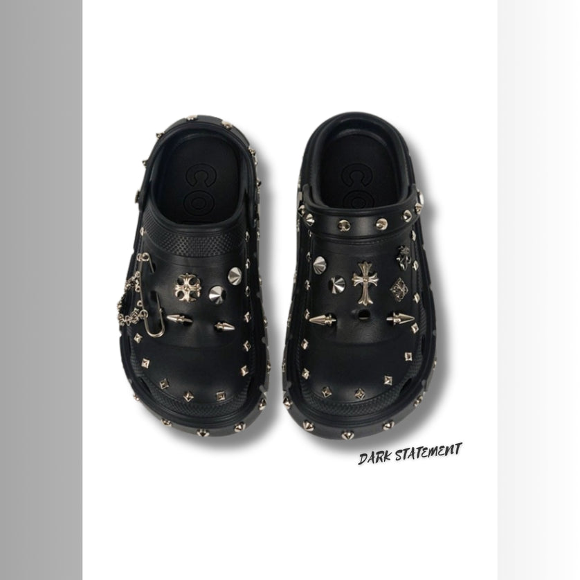 Black platform with rivets clogs on a white background with 'Dark Statement' brand.